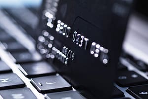 Credit card defaults rise as UK households struggle under mounting financial pressure Credit card on laptop Rafe Swan Avalon