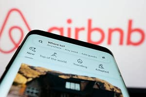 Mobile phone with webpage of US homestay marketplace company Airbnb Inc. on screen. Stuttgart, Germany - 11-30-2022: Mob