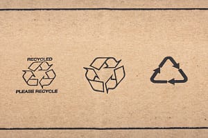 Recycle signs printed on cardboard box WETZLAR, GERMANY - 2022-07-16: Recycle signs printed on cardboard box in Detail.