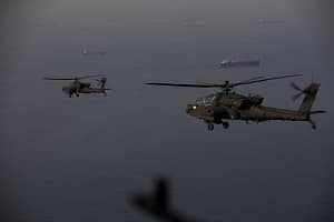 U.S AH-64 Apaches fly above the Strait of Hormuz during a patrol, April 17, 2026. U.S. Army Soldiers are flying in and around the Strait of Hormuz providing a visible presence in support of blockade operations against Iran in the Strait of Hormuz.