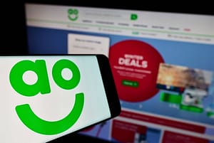 AO World buys Jessops from Peter Jones as shares fall on cautious outlook Mobile phone with logo of British online retail company AO World plc on screen. Stuttgart, Germany - 01-08-2022: Mobile
