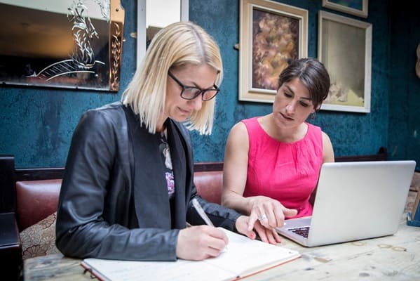 Women brainstorming business ideas in restaurant