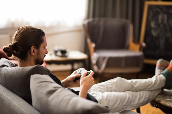 Man playing video game at home