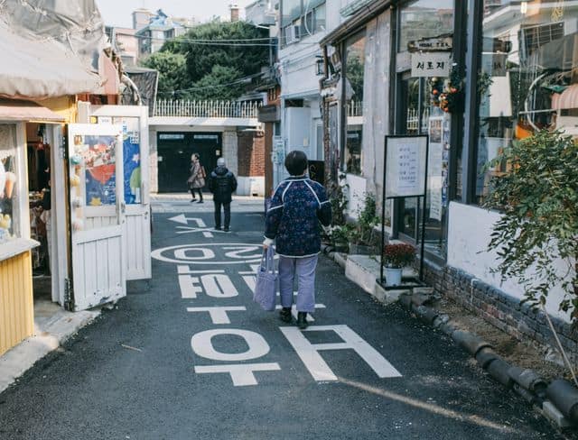Shoppers and pedestrians filling a busy shopping street in Seoul