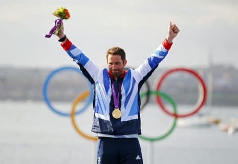 Great Britain's Ben Ainslie celebrates on the podium after winning the Gold medal in the Finn class sailing in Weymouth, during day nine of the London 2012 Olympics.