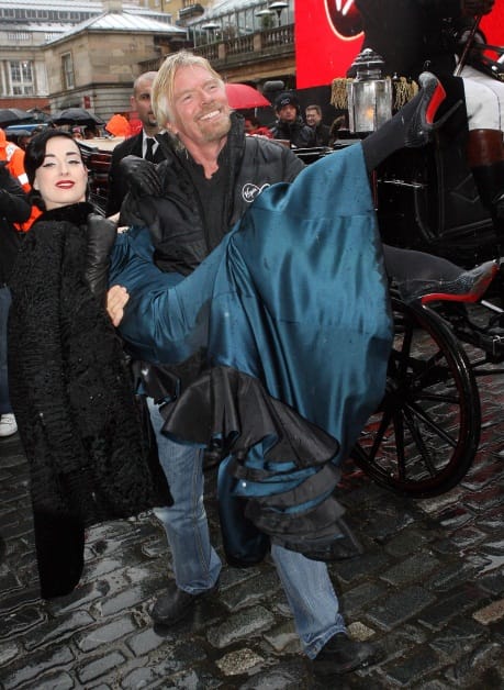 Richard Branson carries Dita Von Teese at the press launch of Virgin Media in Covent Garden, 2007