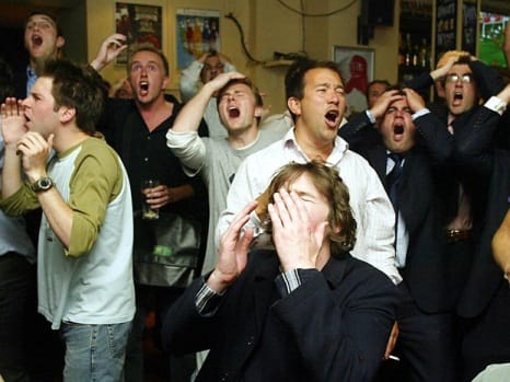 English fans watch England against Portugal in the Euro 2004 quarter-final, at the Elusive Camel pub in Victoria, London.