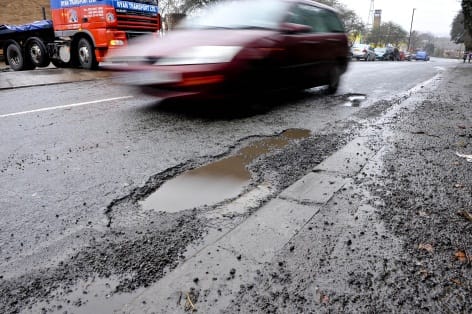 A car driving past a pothole in London
