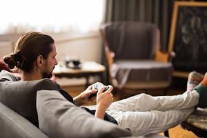 Man playing video game at home