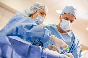 Surgeons Operating On Patient