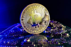 Bitcoin – close up shot in a modern computer technology environment Bitcoin – close up shot in a computer technology env