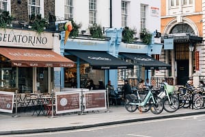 Unknown people enjoy a breakfast sitting on the terrace of a cafe in London London, UK – August 25, 2023: Unknown people
