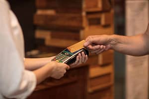 Cropped view of customer making contactless payment
