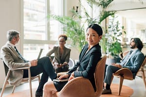 A third of women calling for menopause support at work this Menopause Awareness Month Italy, Portrait of businesswoman at meeting in creative studio