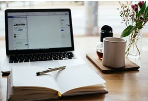 Laptop with notepad and pen