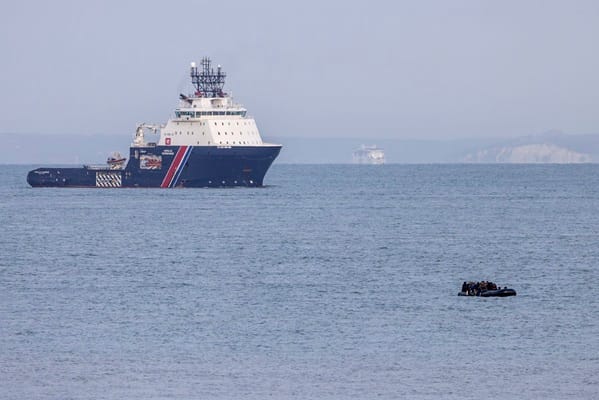 Migrant boat trying to cross the Channel  with the tug Abeille Normandie and the