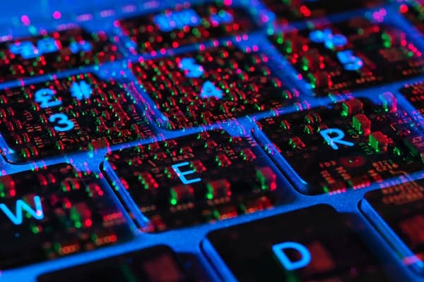 Double exposure of the inside and out of a laptop computer showing the electronic components under the keyboard