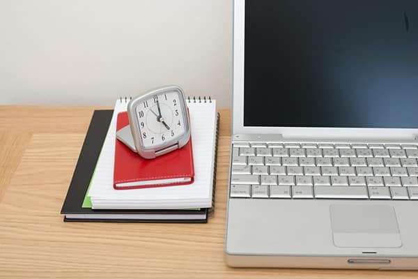 Laptop, notebooks and alarm clock