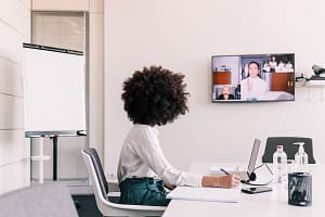 Businesswoman alone in office, making video call