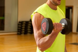 Man in gym using dumbbell