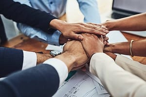 Hands together, business people in meeting and solidarity, support and team huddle with collaboration. Group of employee