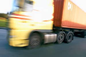 Articulated container truck on the road.