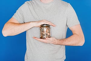 Man holding a jar of coins