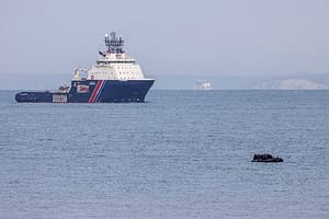 Migrant boat trying to cross the Channel  with the tug Abeille Normandie and the