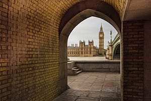 View of Big Ben and Houses of Parliament, seen through archway, London, England