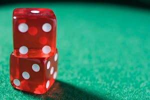 Dice sitting on a poker table (close up/selective focus)