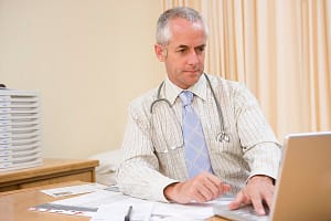 Doctor using laptop in doctor’s office