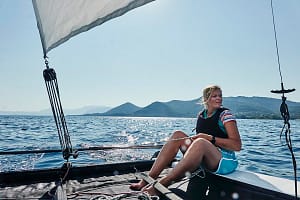 Woman on sailboat in sea off Paleros, Greece