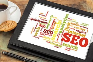 search engine optimization – SEO cloud of words or tags related to SEO (search engine optimization) on a digital tablet