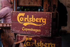 Old wooden crates of Carlsberg beer stand in a bar in Copenhagen, Denmark Old wooden crates of Carlsberg beer stand in a