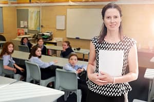 Primary school female teacher teaching in classroom