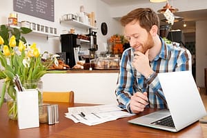 Male customer filling in application form in cafe
