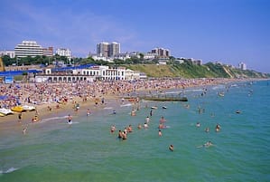 Holidaymakers in the sea and on the beach Bournemouth Dorset England UK PUBLICATIONxINxGERxSUIxA