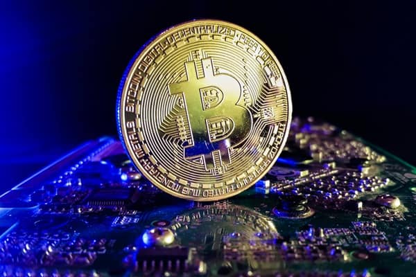 Bitcoin – close up shot in a modern computer technology environment Bitcoin – close up shot in a computer technology env